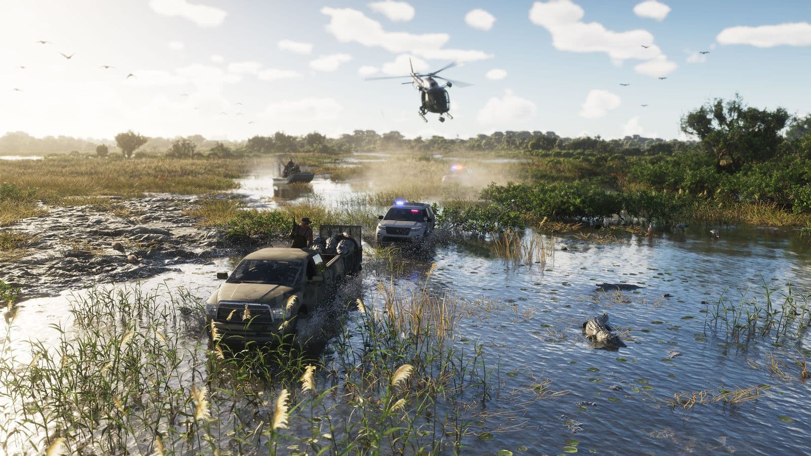 A police helicopter and patrol cars chase a pickup truck through the Grassrivers swamp