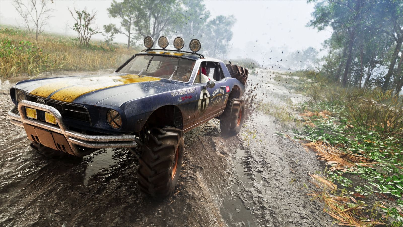 A lifted, mud-spattered Vapid buggy with roof lights tearing along a dirt track